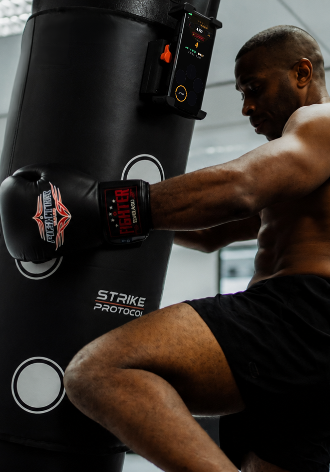 Fighter training solo on heavy bag in garage gym